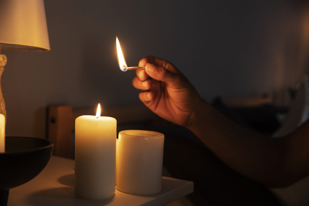 side-view-hand-lighting-candle